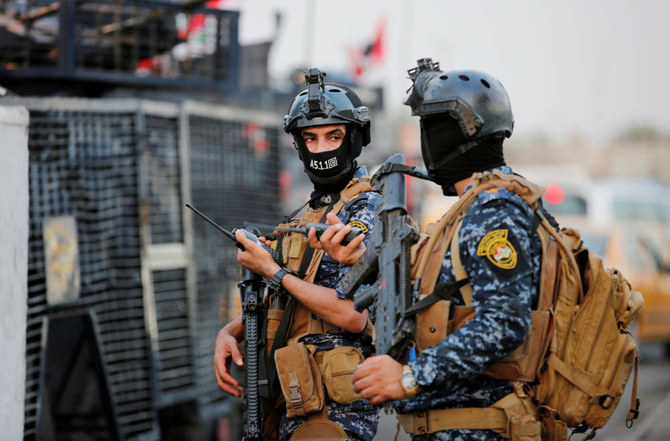 Members of Iraqi federal police are seen with military vehicles in a street in Baghdad, Iraq. (REUTERS file photo)