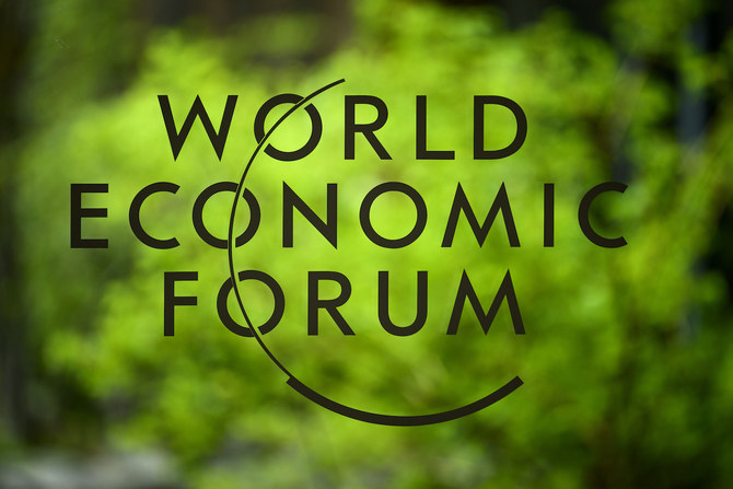 The logo of the WEF is seen on a window in front of trees in Davos, Switzerland, on Sunday, May 22, 2022. (AP)