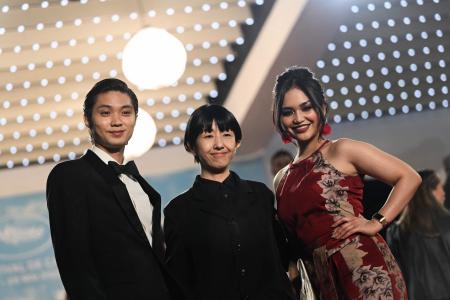 (From left) Japanese actor Hayato Isomura, Japanese director and screenwriter Chie Hayakawa and Filipino actress Stefanie Arianne pose as they arrive for the screening of the film 