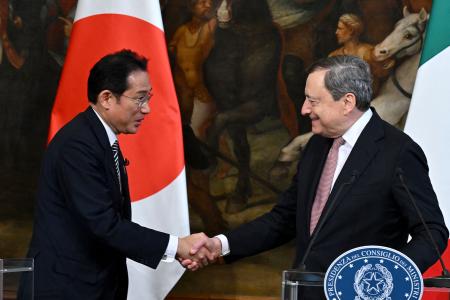 Italian Prime Minister Mario Draghi (right) shakes hand with Japanese Prime Minister Fumio Kishida (left) during a statement to the press after their meeting at the Palazzo Chigi in Rome on May 4, 2022. (AFP)