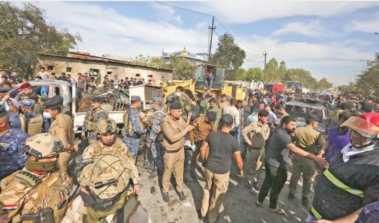 Members of the Iraqi army and security forces gather at the scene of a deadly explosion carried out by Daesh terrorists in Baghdad last year. (AFP)