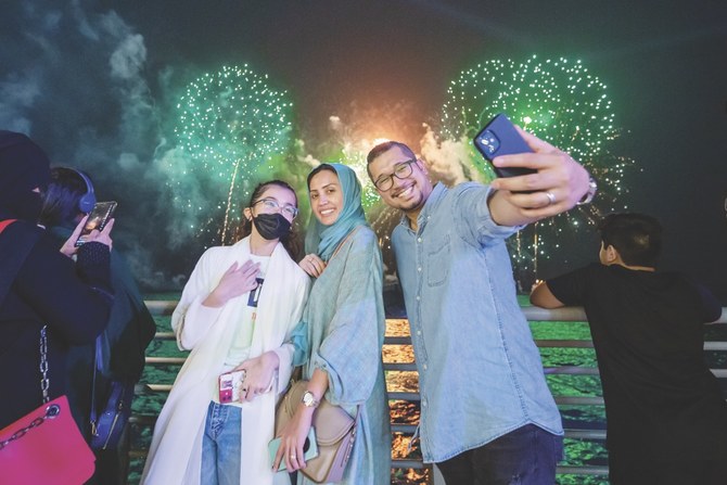 Visitors took souvenir photos of themselves during firework displays and live performances and shows. (SPA)