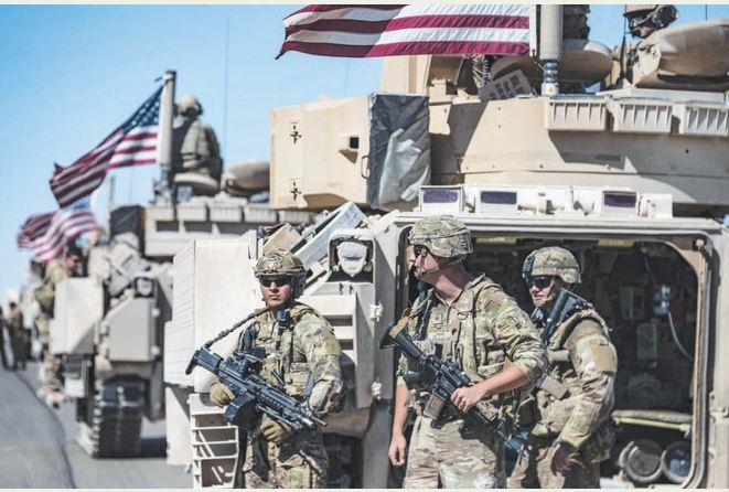 American forces patrol near the countryside of Rumaylan in Syria’s northeastern Hasakeh province near the border with Turkey. (AFP)