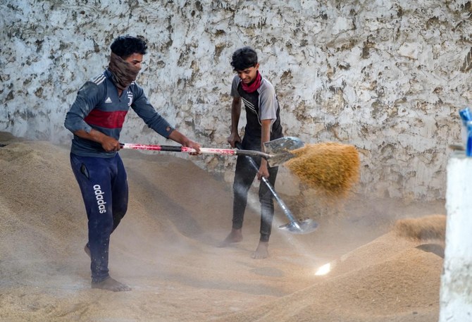 Men work in a rice mill in Iraq’s central province, on May 1. Drought is threatening the Iraqi tradition of growing amber rice, the aromatic basis of rich lamb and other dishes, and an important sector in a struggling economy. (AFP)
