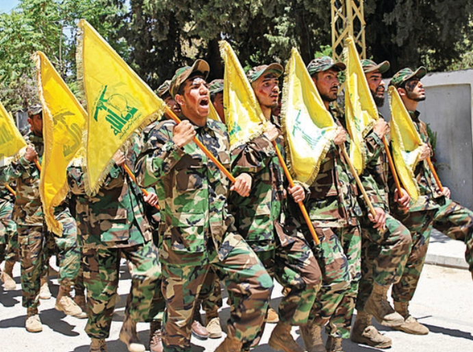 Fighters of the Hezbollah militia take part in a parade in Baalbek, Lebanon, on May 25, 2022. (AFP)