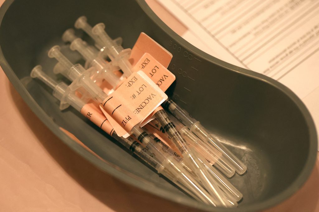 Syringes filled with COVID-19 vaccine sit on a table at a COVID-19 vaccination clinic on April 06, 2022 in San Rafael, California. (AFP)