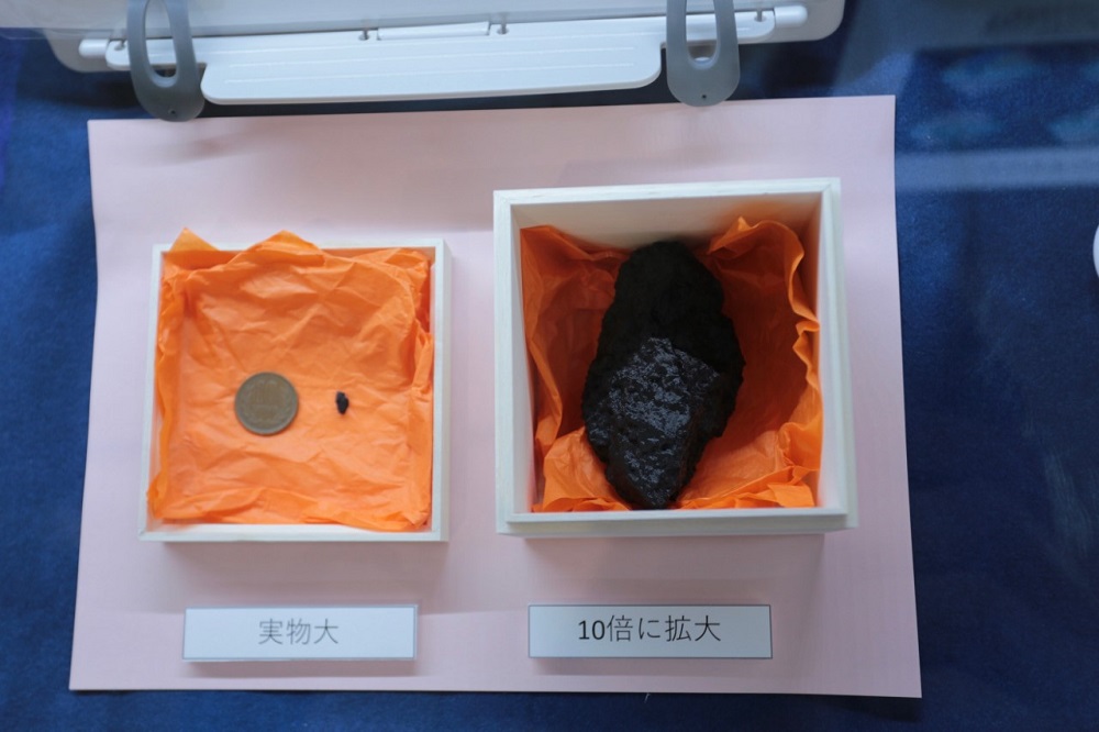 A replica sample from the Ryugu asteroid is displayed at Kokubunji Peace Plaza. (ANJ)