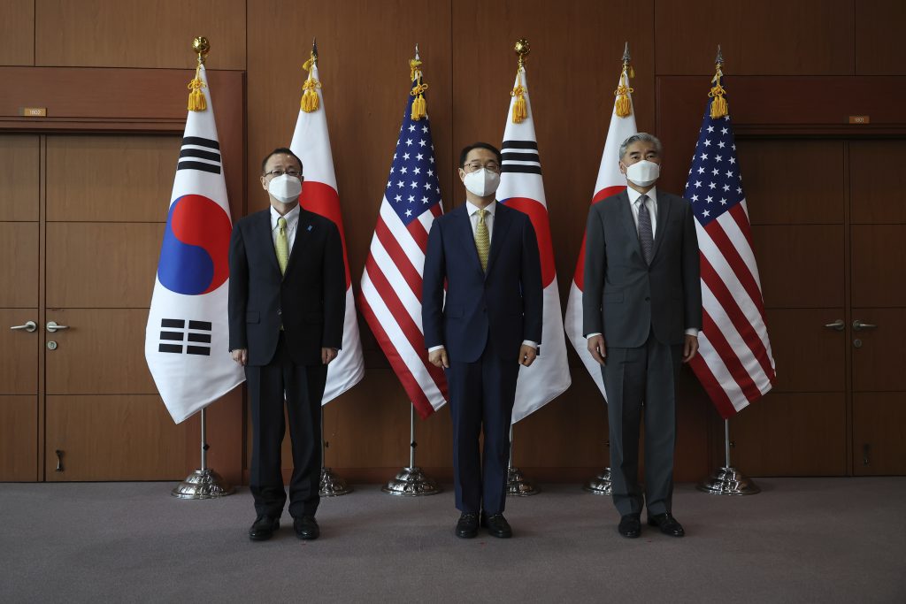 Kim Gunn, center, South Korea's new special representative for Korean Peninsula peace and security affairs, his U.S. counterpart Sung Kim, right, and Japanese counterpart Takehiro Funakoshi pose for photographs before their meeting at the Foreign Ministry in Seoul, South Korea Friday, June 3, 2022. (Kim Hong-Ji/Pool Photo via AP)