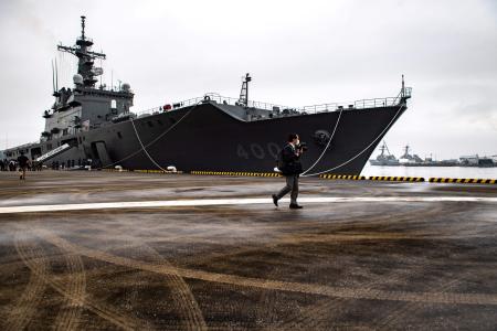 A reporter walks past the JS Osumi (LST-4001) of the Japan Maritime Self-Defense Force as military service members from 18 countries gather for a military display on the sidelines of the PALS 22. (AFP)
