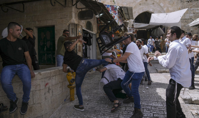 Palestinians and Jewish youths clash in Jerusalem's Old City as Israelis mark Jerusalem Day, an Israeli holiday celebrating the capture of the Old City during the 1967 Mideast war, May 29, 2022. (AP)
