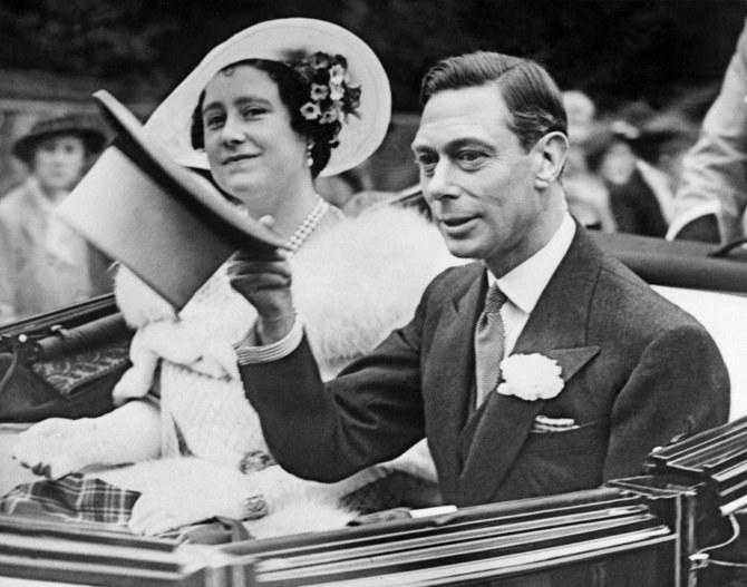 Queen Elizabeth watches as King George VI salutes well-wishers on June 26, 1938 in London. (AFP)