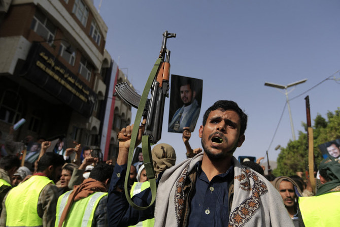 Houthi fighters show off their weapons and raise portraits of their leader Abdul Malik Al-Houthi during rally in Sanaa on June 3, 2022(. AFP)