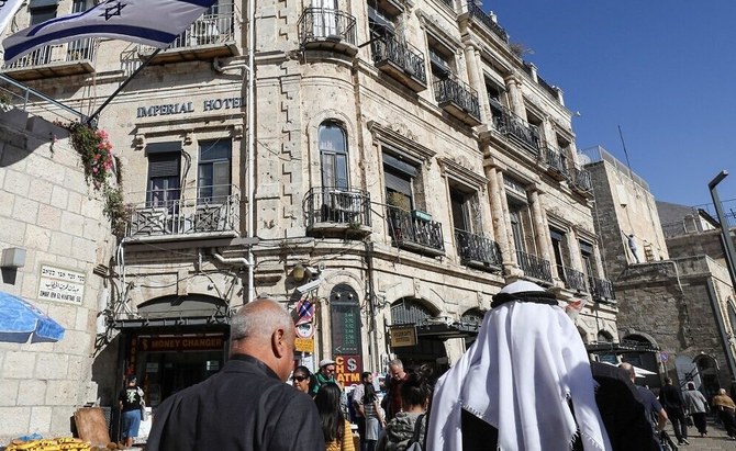 People walk past the Imperial Hotel located next to the Jaffa Gate in the Christian Quarter of Jerusalem’s Old City on November 29, 2019. (AFP)