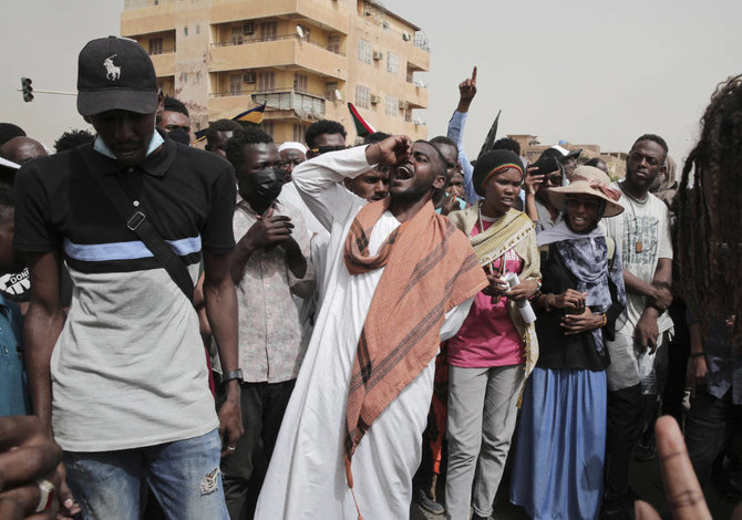 Sudanese protesters commemorate the third anniversary of a deadly crackdown carried out by security forces on protesters during a sit-in outside the army headquarters, in Khartoum, Sudan, Friday, June 3, 2022. (AP)
