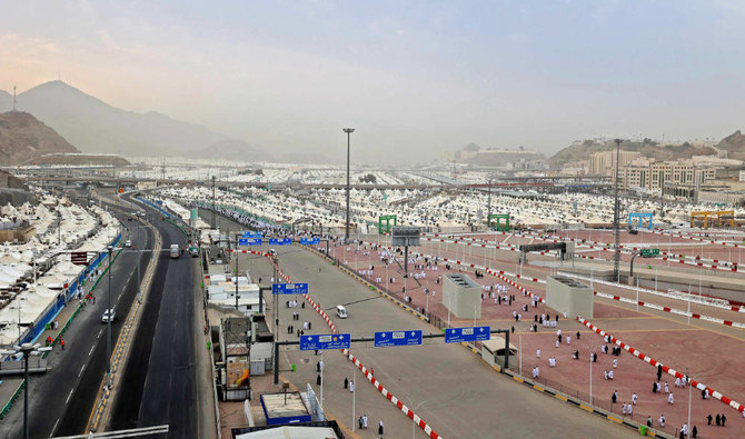 Muslim worshippers set out to perform a symbolic stoning of the devil ritual, as part of the Hajj pilgrimage in Mina, near Saudi Arabia's holy city of Makkah, on July 20, 2021. (AFP)