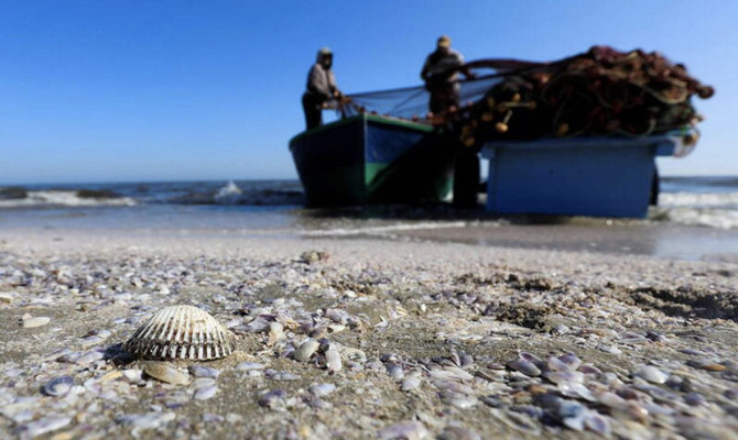 Egyptian fishermen raise their nets without fish along a beach in the Red Sea shore at Port Said city, northeast of Cairo, on May 27, 2022. (REUTERS/Amr Abdallah Dalsh)