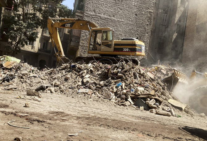 A bulldozer removes the debris following the collapse of a building in Cairo on Friday. (AP)