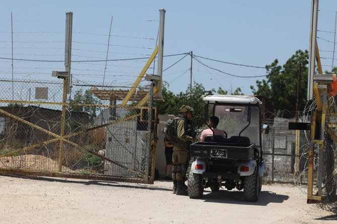 Israeli security forces stop a vehicle at a crossing where a Palestinian worker was shot dead on Sunday in the West Bank where an Israeli settler stabbed a Palestinian man to death on Tuesday. (AFP)