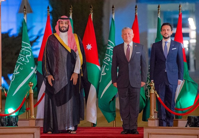 Jordan's King Abdullah II (C) and his son Crown Prince Hussein (2nd-R) receiving Saudi Crown Prince Mohammed bin Salman at Queen Alia International Airport on the southern outskirts of Jordan's capital Amman on June 21, 2022. (AFP)