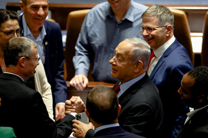 Former Israeli Prime Minister Benjamin Netanyahu is surrounded by Likud party members as he attends a preliminary reading at the Israeli parliament of a bill to dissolve the parliament. (Reuters)