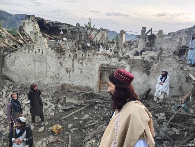 In this photo released by a state-run news agency Bakhtar, Afghans look at destruction caused by an earthquake in the province of Paktika, eastern Afghanistan on Wednesday. (AP)