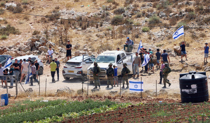 Israeli security forces deploy as settlers from the settlement of Eli try to take control of a water spring in the Palestinian village of Qaryut, south of Nablus, West Bank, on June 24, 2022. (AFP)