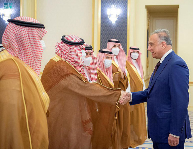 Iraqi Prime Minister Mustafa Al-Kadhimi interacts with Saudi officials who welcomed him at Jeddah's King Abdulaziz International Airport. (SPA)