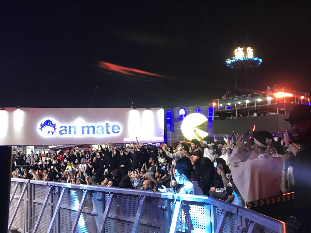 Fans cheering and waving their hands during one of Flow flaming songs.