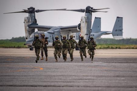 Members of the Japan Ground Self-Defense Force take part in a military display in front of a V-22 Osprey, for service members from 18 countries on the sidelines of the PALS 22. (AFP)