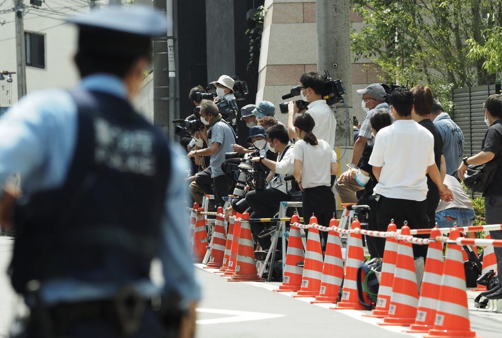 Journalists gather outside the residence of former Japanese Prime Minister Shinzo Abe in Tokyo on July 11, 2022. (AFP)