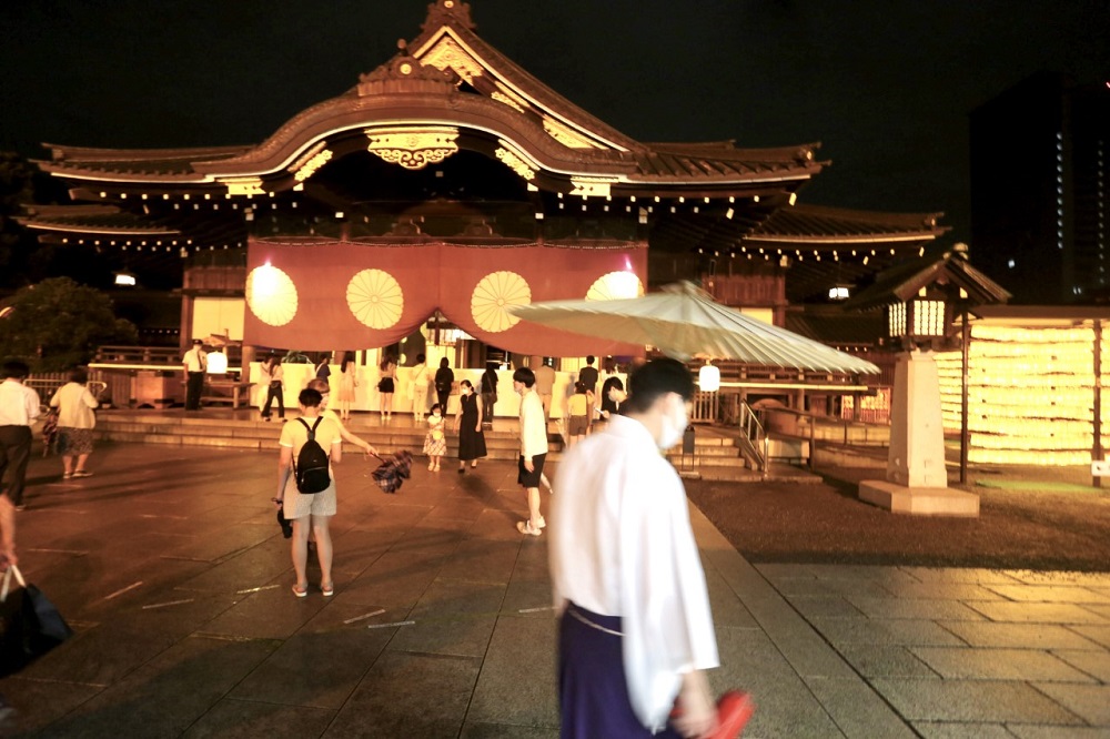 Visitors take photos at the Mitama Festival at Yasukuni Shrine in Tokyo to observe the lantern illuminations and mark the remembrance of ancestors who sacrificed their lives for the country. (ANJP/ Pierre Boutier)