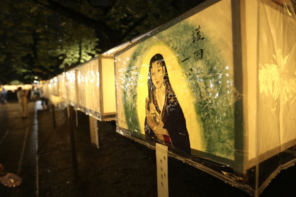 Visitors take photos at the Mitama Festival at Yasukuni Shrine in Tokyo to observe the lantern illuminations and mark the remembrance of ancestors who sacrificed their lives for the country. (ANJP/ Pierre Boutier)
