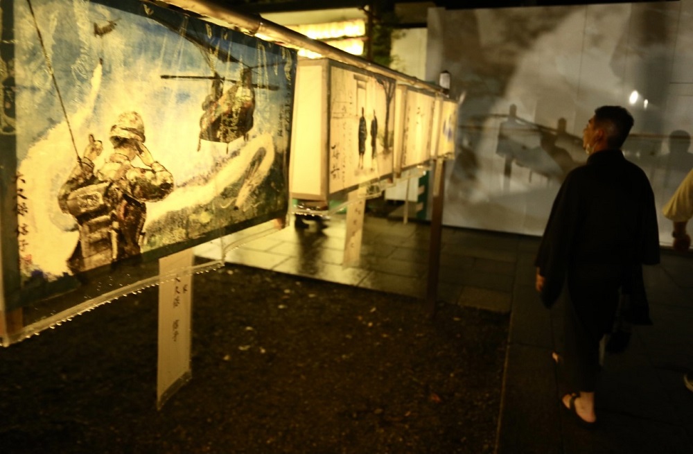 Visitors take photos at the Mitama Festival at Yasukuni Shrine in Tokyo to observe the lantern illuminations and mark the remembrance of ancestors who sacrificed their lives for the country. (ANJP/ Pierre Boutier)