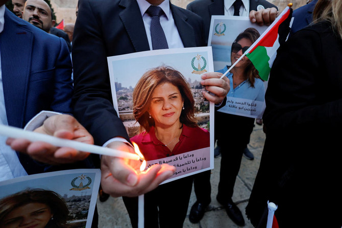 People light candles during a vigil in memory of Al Jazeera journalist Shireen Abu Akleh, who was killed during an Israeli raid, outside the Church of the Nativity in Bethlehem, May 16, 2022. (Reuters)