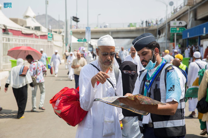 A volunteer guides an elderly pilgrim in navigating the Grand Mosque in Makkah as he performs Hajj on July 6, 2022. (SPA)