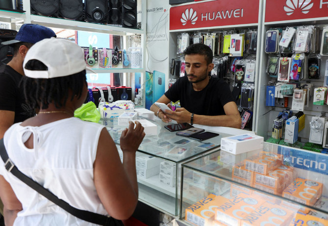 A vendor assists customers inside a mobile shop in Dora, Lebanon July 9, 2022. (REUTERS)