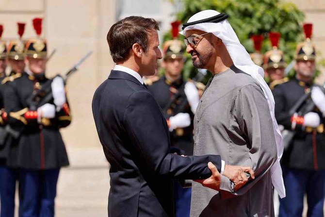 French President Emmanuel Macron welcomes UAE President Sheikh Mohamed bin Zayed Al-Nahyan as he arrives for a meeting at the Elysee Palace in Paris. (Reuters)