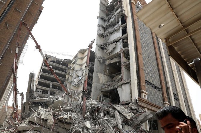 Iranians gather at the site where a ten-storey building collapsed in the southwestern city of Abadan on May 23, 2022. (Tasnim News/AFP)