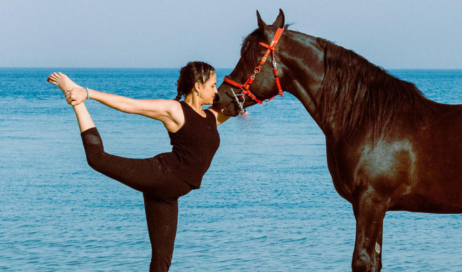 Dana Al-Gosaibi practicing horse yoga in Alkhobar beach. (Supplied)