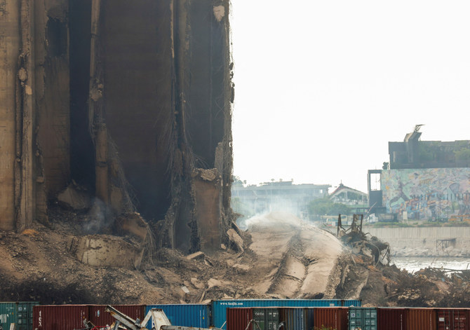 Dust rises as part of Beirut grain silos, damaged in the August 2020 port blast, collapses in Beirut Lebanon July 31, 2022. (Reuters)