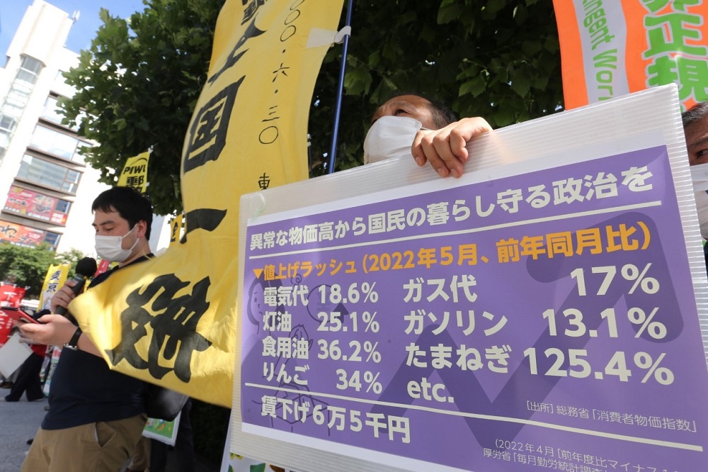 A protester holds a banner outlining the percentage of the price rise in the utilities. (ANJ/ Pierre Boutier)