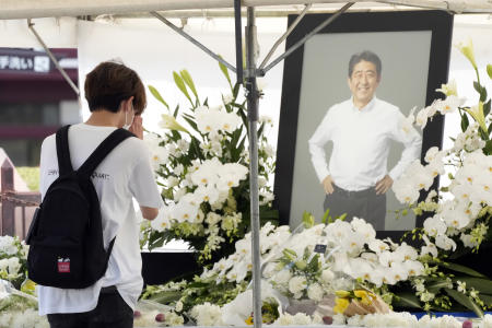 A person offers flowers and prayers for former Prime Minister Shinzo Abe, at Zojoji temple prior to his funeral wake Monday, July 11, 2022, in Tokyo. (AP)