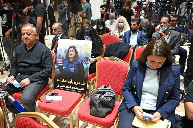 A photo of slain US-Palestinian Al Jazeera correspondent Shireen Abu Akleh, with a caption in Arabic reading “Shireen Abu Akleh, the voice of Palestine.” (MANDEL NGAN/AFP)