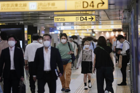 People wearing face masks walk underground near a train station in Tokyo, Thursday, July 14, 2022. (AP)