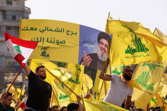 Supporters of Lebanon’s Hezbollah leader Sayyed Hassan Nasrallah hold flags during an election rally in Tyre, Lebanon. (Reuters)