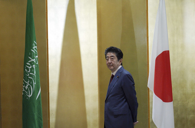 Japanese Prime Minister Shinzo Abe waits for Saudi Arabia’s Crown Prince Mohammed bin Salman prior to their meeting in Osaka on June 30, 2019. (AFP)