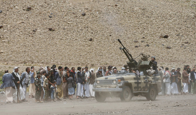 A Houthi fighter opens fire into the air as they parade during a gathering of Houthi loyalists in Sanaa in July 2020. (Reuters/File)