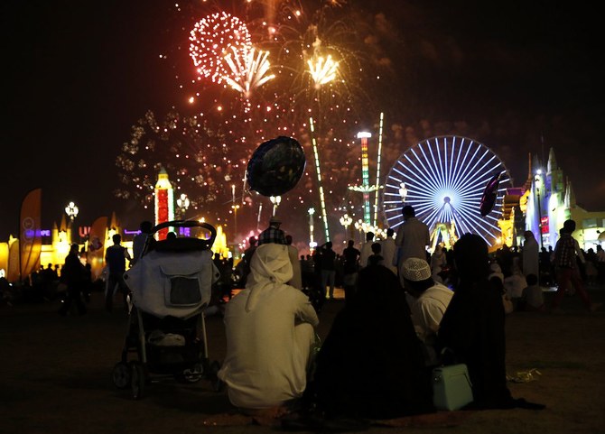 An Emirati family watches the fireworks display at the Global Village in Dubai. (Reuters)