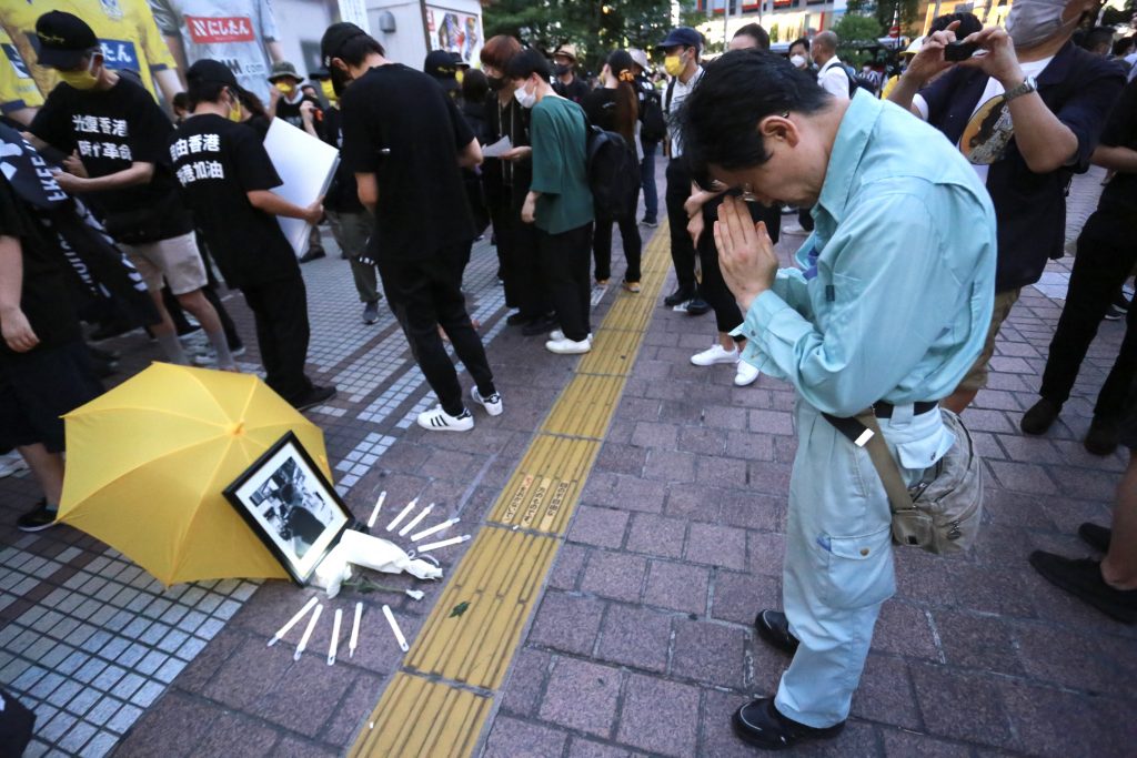 People opposed to China’s government demonstrate in Tokyo's bustling Shibuya district. (ANJP Photo)