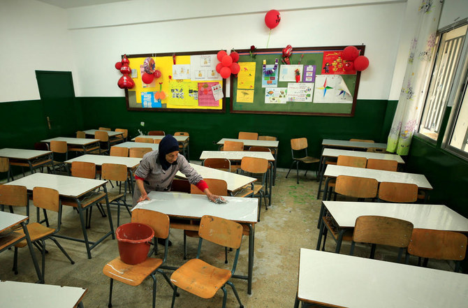 A worker cleaning an empty classroom in a school in Lebanon. The country’s three-year-old economic crisis has demoralised teachers to take up well-paid jobs in the Gulf. (Reuters)